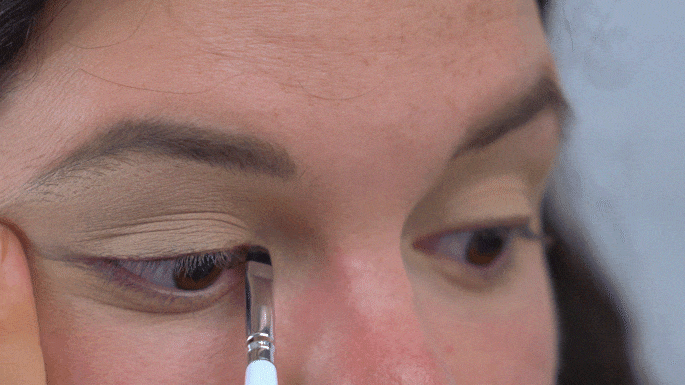 Ansley applying brown eyeliner