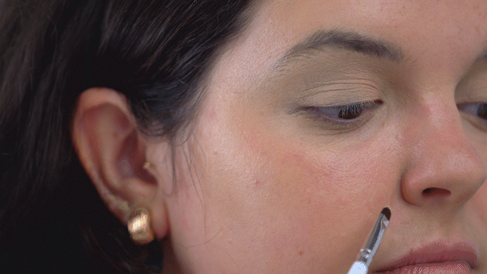 Ansley applying concealer to the center of patch