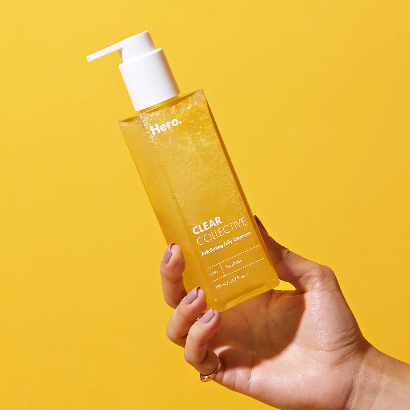 Hand holding the Clear Collective Exfoliating Jelly Cleanser