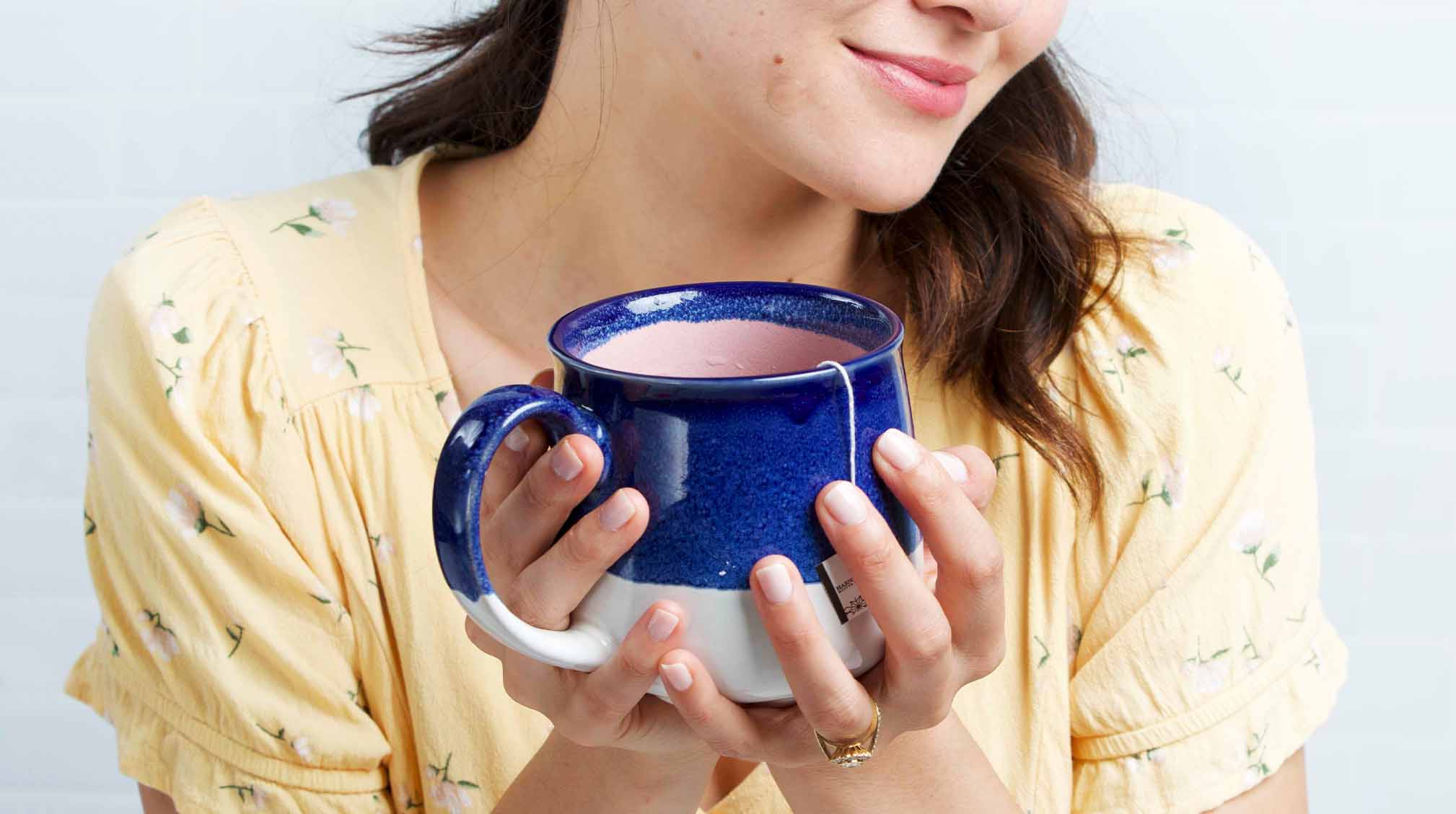 Duan holding a cup of tea