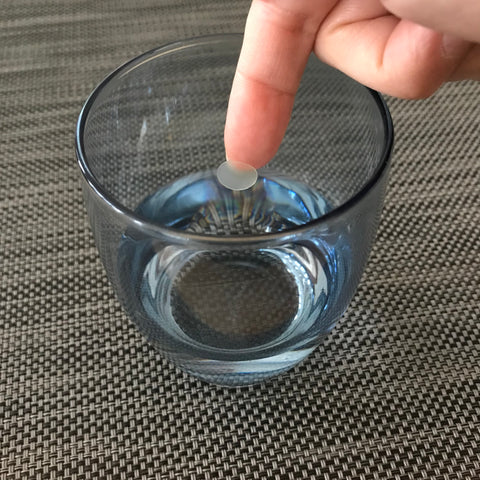 patch being dipped in water for absorbency test