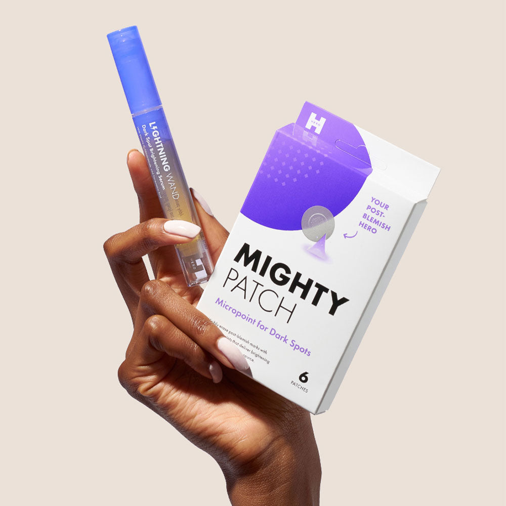 Hand holding lightning wand and micropoint for dark spots
