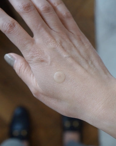 hand with mighty patch on top of the cut